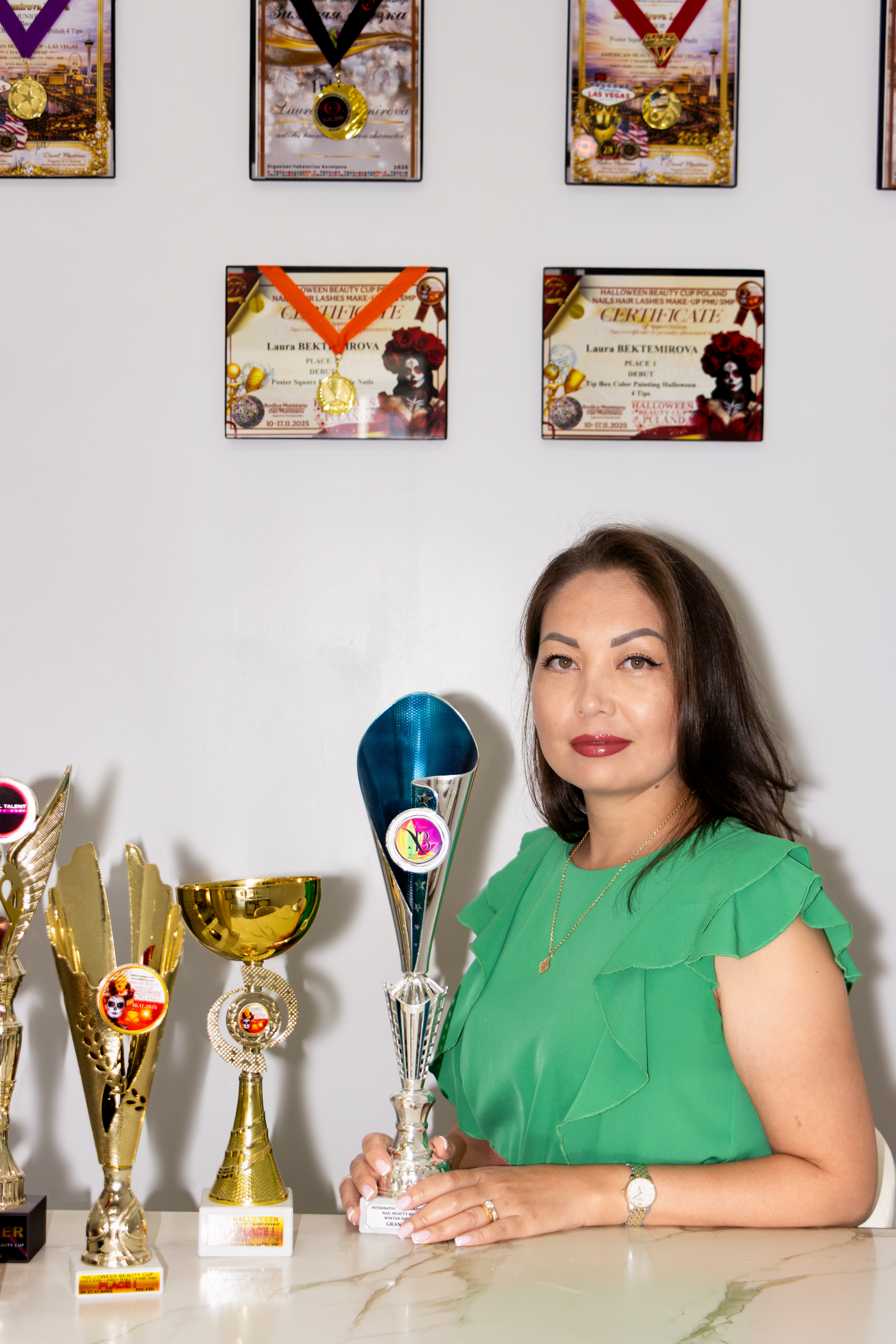 Laura Bektemirova with her championship trophies, medals and certificates